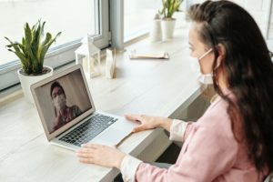 Masked Woman on Laptop